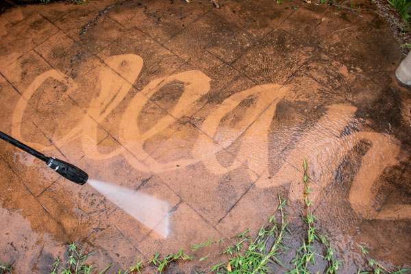 "Clean" sprayed into dirt on driveway