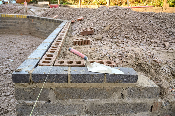 Exterior wall being built in garden